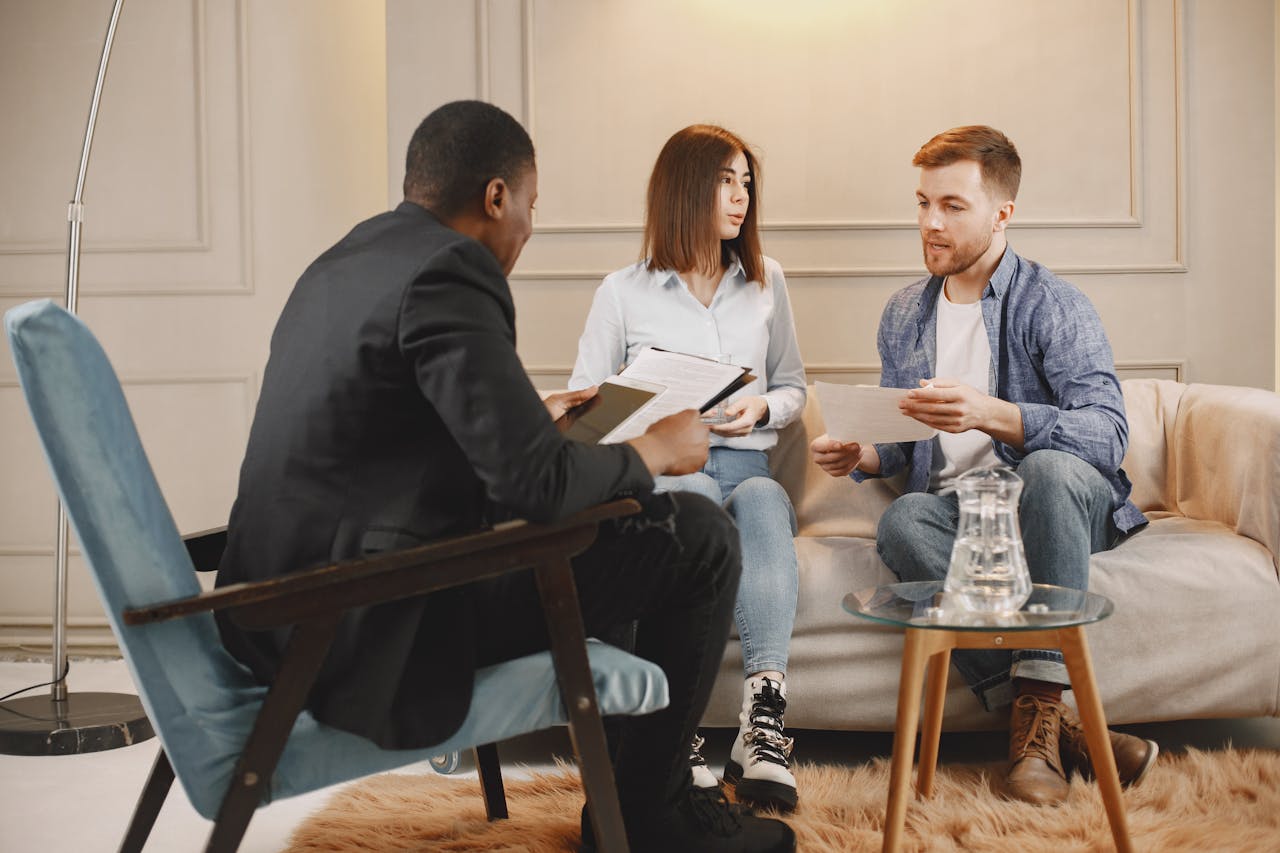 A counseling session with a diverse group of adults discussing issues in a cozy setting.