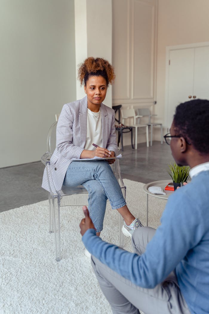 Mastering the First Impression: Your intriguing post title goes here Professional therapist discussing with a client in a modern office setting.